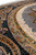 Curved black main border with copper arabesque beside sage guard stripe and slate blue field