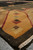 Gold cartouche with stepped squares along the border of this oversized modern Indian wool rug