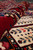 Rolled edge of the rug showing plush pile depth next to a cream willow panel