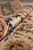 Rolled edge close-up of navy border showing fine knotting and natural wool luster
