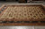 Ivory all-over floral hand-knotted rug displayed on grey tile floor under warehouse overhead lighting