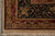 Close corner detail of navy, rust and camel border bands with ivory selvage