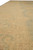 Long-side perspective of 9'3 x 11'8 wool rug showing border stripes and open gold field