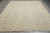 Soft blue Ziegler rug photographed flat on grey tile floor showing beige palmettes and scrolling vines