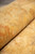 Soft wool pile rolled to show honey and apricot tones and subtle abrash striations