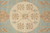 Detail of ivory circular medallion with 8 petal rosettes, hearts and slender connecting vine