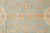 Close-up of octagonal tan and ivory rosette panels set against the soft blue ground