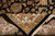 Folded corner revealing tight hand-knotted back, cotton foundation and ivory border of the wool rug