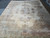 11x15 Kerman rug photographed from one end showing full pastel border and ivory center