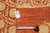 Back of rug with tag reading 32030 and tape measure confirming 9'10" x 14'1" size