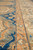 Border detail with coral guard stripe dividing the blue field from the ivory floral border