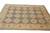 Hand-knotted Peshawar Chobi rug seen from the corner, ivory border framing blue all over medallions