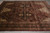 8'10" x 11'9" Jaipur rug photographed on grey tile, showing black medallion and burgundy field