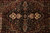 Detail of black center medallion with ivory palmettes, sage scrollwork and deep burgundy surround