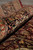 Rolled edge close-up showing black border, salmon guard stripe and thick soft wool pile
