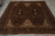 Full length view of burgundy traditional rug with ivory cornerpieces, cotton fringe and layered borders