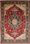 10x14 Serapi Chobi rug shown flat with ruby red field and navy floral border