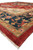 Standing corner view of ivory spandrel, indigo border and garnet red wool pile