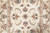 Overhead detail of the all over floral field with palmettes, vine scrolls and guard border stripes