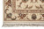 Corner close up showing ivory border, rust outlines, black leaf tips and hand-tied cotton fringe