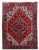 Full view of 7'11 x 10'11 Persian Heriz rug with red field and ivory corner spandrels