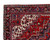 Corner close-up of the ivory spandrel, aubergine main border and rosette guard stripes on this Persian rug