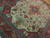 8x12 Persian Tabriz rug angled view showing ivory ground, floral vines and deep red border
