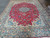 Hand-knotted wool Persian rug with red field, blue vases and green floral main border