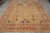8x12 hand-knotted Agra Oriental rug displayed flat on grey tile showroom floor