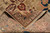 Back of the rug folded over showing dense hand-knotted weave and ivory fringe