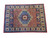Hand-knotted wool Oriental rug photographed at an angle showing navy end panels and ivory border