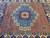 Overhead of red all over lattice field with satellite octagons framing the blue medallion