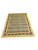 Angled full view showing the gold border, black leaf accents and striated sage green field