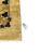 Original inventory tag reading 6378 beside the gold border of this Pakistani wool rug