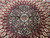 Detail of the round medallion framed by rows of cream and gold cartouche panels