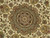 Close-up of the central medallion with burgundy core, cream palmettes and green leaf motifs