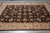 Black brown all over floral field framed by a wide ivory border on grey tile