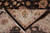 Folded corner revealing tight hand-knotted back, cotton warps and cream fringe of the wool rug