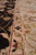 Close view of ivory main border, salmon guard stripe and black cloudband scrolls