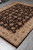 8 x 10 Zigler rug photographed from the corner showing ivory border scrollwork and dark floral field