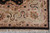 Corner detail of beige border with sage vines, rust blossoms and black cross motifs