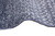 Overcast selvage edge detail on indigo and silver wool pile, curved to show flexibility