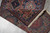Folded corner revealing the back weave, knot density and hand-tied ivory fringe on this runner