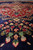Flowering spray detail in coral, green and ivory rising from the deep navy blue ground