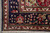 Corner detail with palmettes, rosettes and vine scroll on navy ground above ivory outer guard