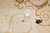 Tape measure and inventory tag F-4074 laid on the ivory rug confirming size and weave