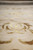 Low angle view of shimmering silk motifs running across the cream field of the rug
