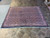 7' x 8'5" Persian Bijar rug displayed on travertine showroom floor with white fringe ends