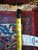 Back of the rug with tape measure and tag reading 9.8 x 13.5, hand-woven oriental rug