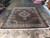8'2" x 9'9" wool and silk Oriental rug displayed on a tiled showroom floor